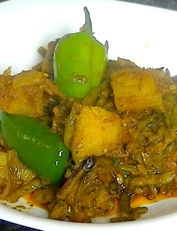 Aloo Mongray with potatoes and radish pods cooked with spices in a traditional Pakistani and Indian style.