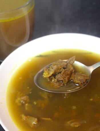 Desi Yakhni (Mutton Broth) served in a bowl with tender mutton pieces and aromatic spices.