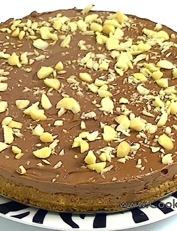 Delicious and creamy Nutella cheesecake topped with chocolate drizzle and hazelnuts.