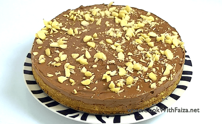 Delicious and creamy Nutella cheesecake topped with chocolate drizzle and hazelnuts.