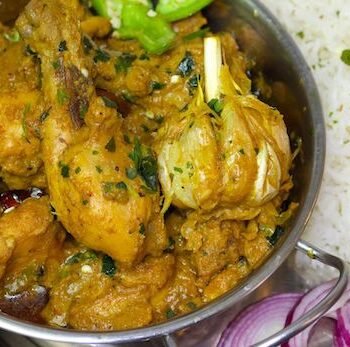 Authentic Champaran Chicken slow-cooked with spices in a clay pot, a traditional Bihari dish.
