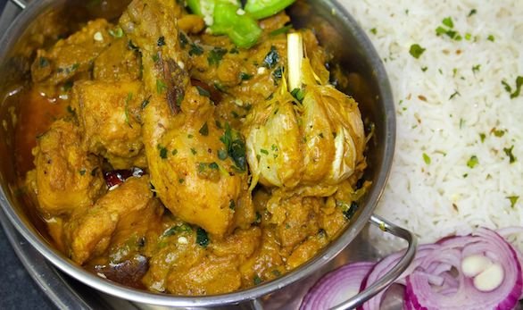 Authentic Champaran Chicken slow-cooked with spices in a clay pot, a traditional Bihari dish.