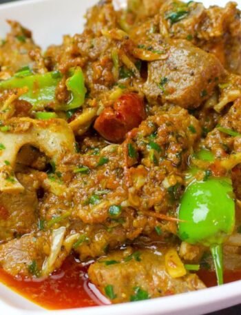 Khada Masala Mutton Karahi served in a handi with green chillies and coriander on top